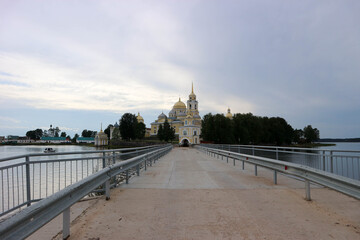 View to the road and entrance gate of Nilov Monastery on Stolobny Island, lake Seliger, Ostashkov,...