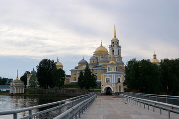 View to the road and entrance gate of Nilov Monastery on Stolobny Island, lake Seliger, Ostashkov, Russia