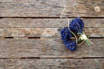 bunches of dried lavender on a brown wooden table