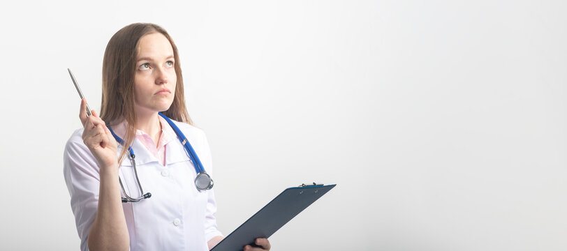 Female doctor with stethoscope looking up careworn while looking analyzing results with pen pointing at top. doctor came up with idea and analyzing on white background, copy space