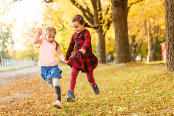 Fototapeta premium two little girls in autumn park