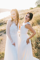 Fototapeta na wymiar Lesbian wedding couple in white dresses