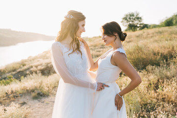 Lesbian wedding couple in white dresses