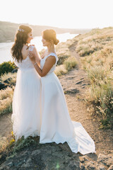 Lesbian wedding couple in white dresses