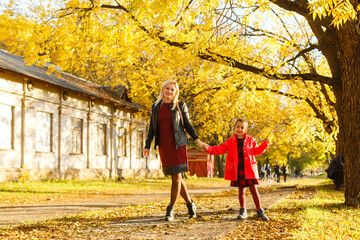 mother with daughter in autumn park