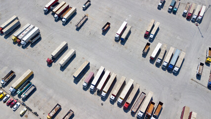 Aerial view of the parked trucks in open area. 