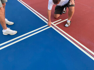 Pickleball lines are masked just before being painted.