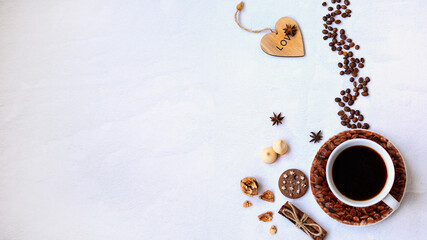 Coffee cup with steam from roasted coffee beans, cookies, walnuts and a heart on a light...