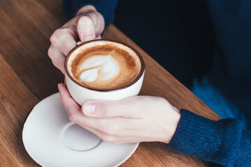 Coffee in the morning. Men hands holding a cup of coffee. Blue sweater, men, cup, coffee, latte, cappuccino, comfort, day.