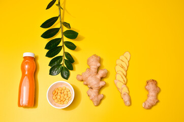 Ginger in different conditions: fresh, dry root, pills and cut plant on pastel yellow orange background.