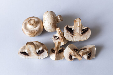Mushrooms lies on a gray background. Champignons photographed at close range. . High quality photo
