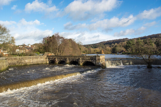 Water flowing under a stone arched bridge