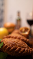 Dinner table with baked potatoes,burgers, sauces, beer and wine