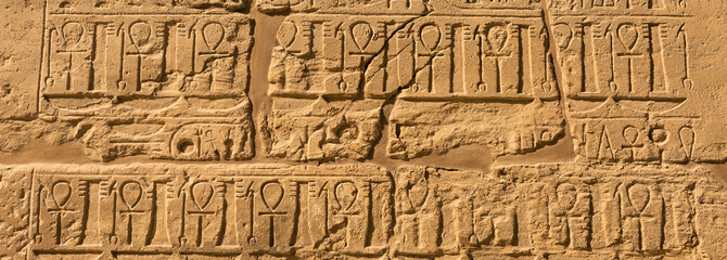 Fototapeta na wymiar Karnak Temple, The ruins of the temple, Embossed hieroglyphs on the wall