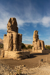 Colossi of Memnon Luxor Thebes against the background of dawn in the Egypt