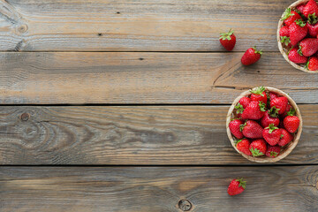 Fresh strawberries on basket top view. Healthy food on wooden table mockup. Delicious, sweet, juicy and ripe berry background with copy space for text