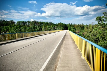 Fototapeta na wymiar Bridge with a yellow railing over the Vltava river