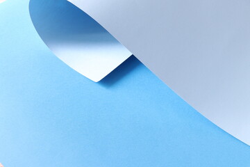 Paper, rolled-up, blue, background. Beautiful light blue background with lights and shadows. Background with rolled-up paper. Shadow, light, geometric. Trend background.