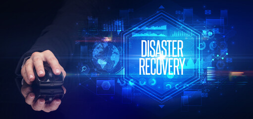 hand holding wireless peripheral with DISASTER RECOVERY inscription, cyber security concept