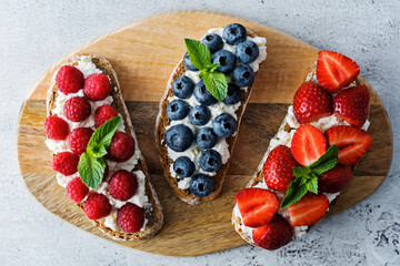 Fresh breakfast with Blueberry, Strawberry and raspberry ricotta rye sandwiches