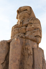 Colossi of Memnon Luxor Thebes against the background of dawn in the Egypt