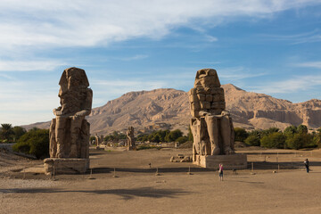 Colossi of Memnon Luxor Thebes against the background of dawn in the Egypt