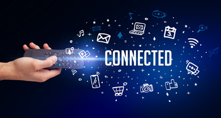 hand holding wireless peripheral with CONNECTED inscription, social media concept