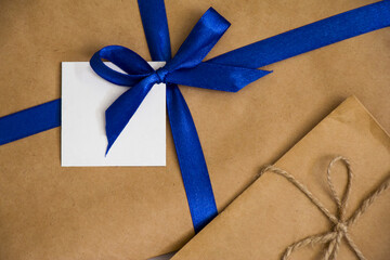 Paper holiday letters with blank label and blue ribbon and rope,top view, copy space for mock up.