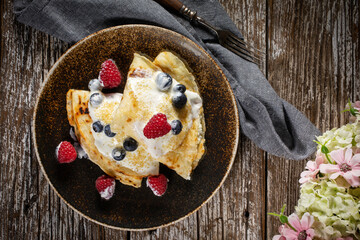 Pancakes with white cheese and fruit.