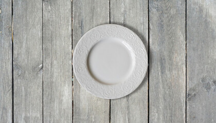 white empty plate on a wooden table top view background