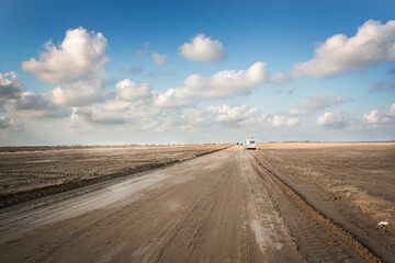 Fototapeta na wymiar desert sand road at the end of the day