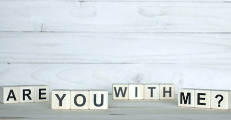 Are you with me? Motivation Concept. The inscription on wooden cubes on a wooden background