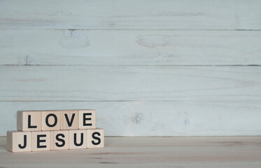 I love jesus. The inscription on wooden cubes on a wooden background
