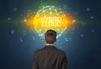 Rear view of a businessman with HYBRID CLOUD inscription, online security concept