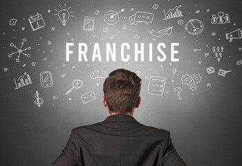 Rear view of a businessman with FRANCHISE inscription, modern business concept