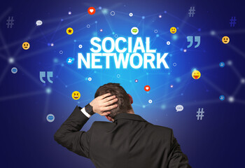 Rear view of a businessman with SOCIAL NETWORK inscription, social networking concept