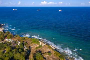 Fototapeta na wymiar A beautiful aerial view from drone to the coastline and ships near horizon