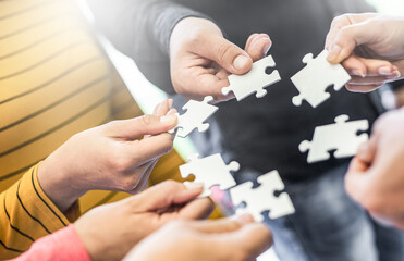 A group of business people assembling jigsaw puzzle.