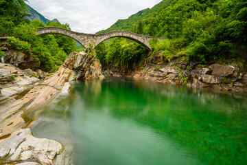 Fototapeta na wymiar Verzasca River at Lavertezzo - clear and turquoise water stream and rocks in Ticino - Valle Verzasca - Valley in Tessin, Switzerland