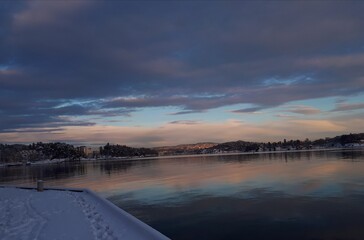 Landscape with snow-covered pier against the backdrop of sunset - Lysaker 