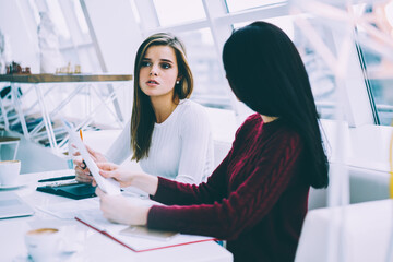 Two friends communicating with each other about ideas on creating own business on internet websites...