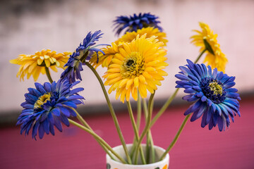 Vase with blue and yellow fabric flowers