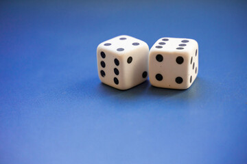Two rubber dice on a blue background