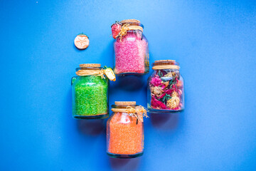 Bottles with bath salts and dried flowers