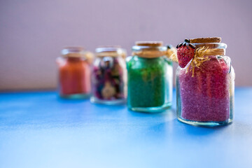 Bottles with bath salts and dried flowers