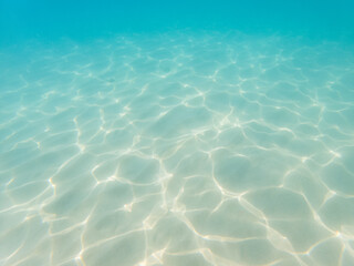Underwater still of the water waves reflection on white sand in the Mediterranean Sea