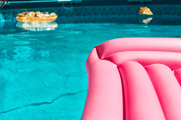 
resting in the pool with a pink mattress
