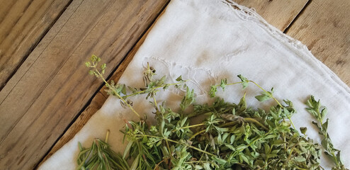 A Bunch of Drying Herbs | Rustic Scene of Herbs on a White Towel and Wooden Boards