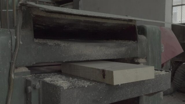carpenter is cutting a wooden plank. Prores 422 HQ with ambiance sound