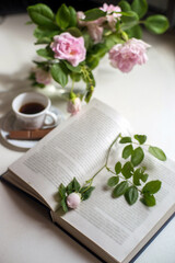 Open book with rose and cofe